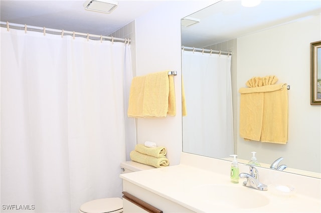 bathroom featuring toilet and vanity