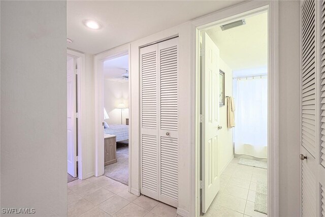 corridor featuring light tile patterned floors