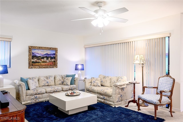 carpeted living room with ceiling fan