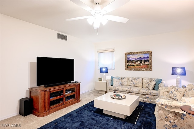 carpeted living room with ceiling fan