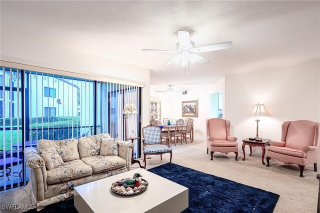 living room with carpet floors and ceiling fan