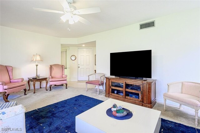 carpeted living room featuring ceiling fan