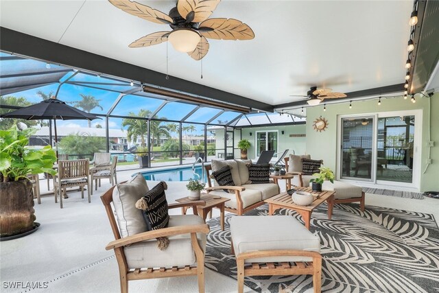 view of patio featuring an outdoor living space, a lanai, and ceiling fan