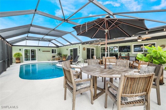 view of pool with ceiling fan, a lanai, and a patio area