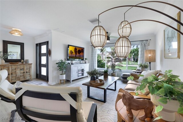 living room featuring ornamental molding and an inviting chandelier