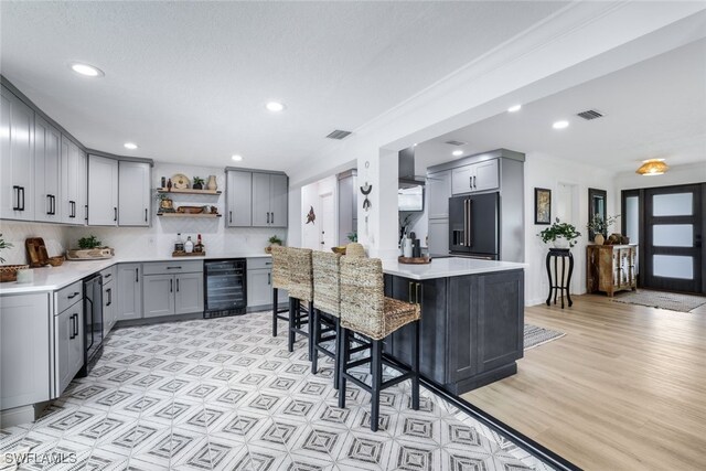 kitchen featuring beverage cooler, gray cabinetry, and high end refrigerator