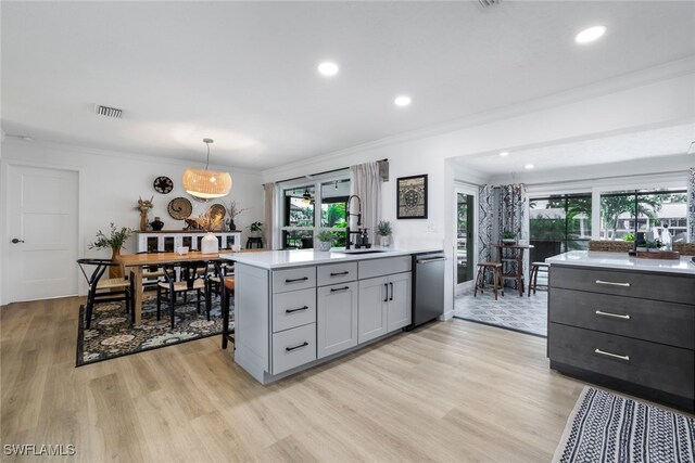 kitchen with gray cabinets, dishwasher, light wood-type flooring, and sink