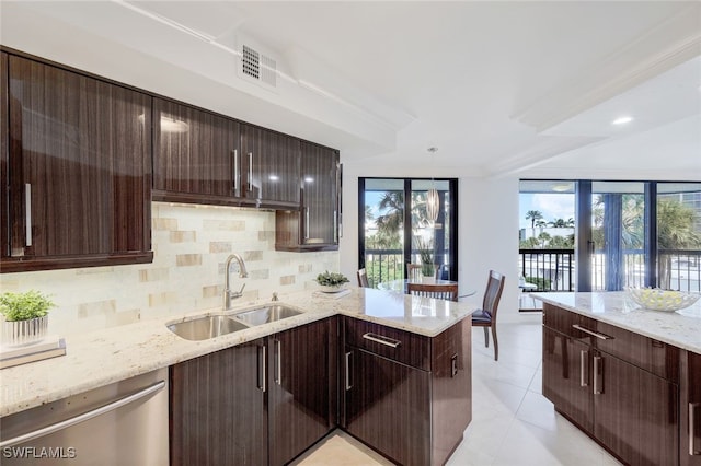 kitchen with dishwasher, sink, and light stone countertops