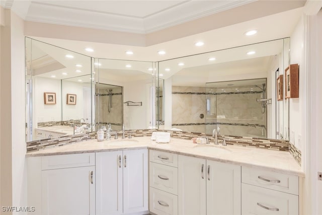 bathroom featuring vanity, a shower with shower door, and ornamental molding