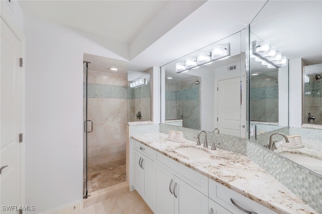 bathroom featuring tile patterned flooring, vanity, and an enclosed shower