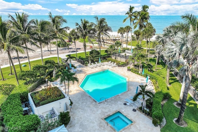 view of swimming pool with a water view and a patio