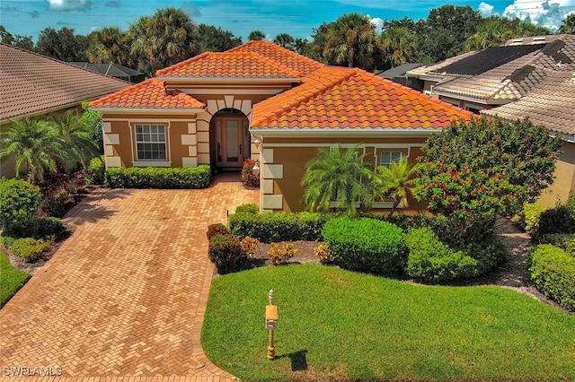 mediterranean / spanish house with a front lawn