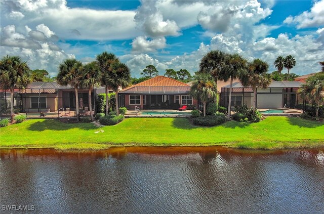 back of property featuring a water view, a yard, and glass enclosure