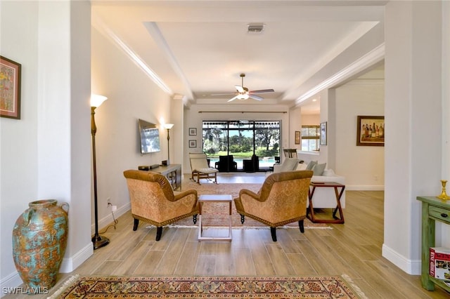 living room featuring ornamental molding and ceiling fan