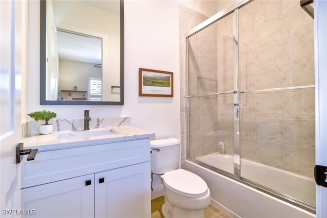 full bathroom with vanity, combined bath / shower with glass door, and toilet