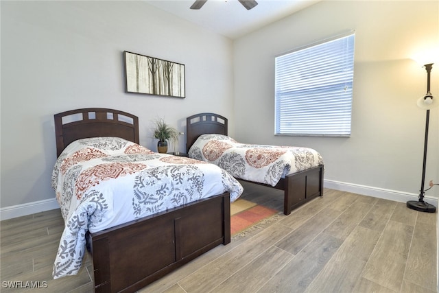 bedroom with hardwood / wood-style flooring and ceiling fan