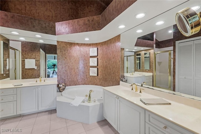 bathroom featuring tile patterned floors, vanity, and plus walk in shower