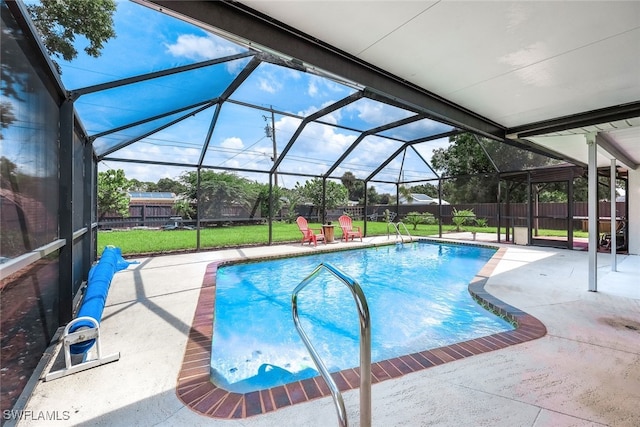 view of swimming pool featuring a lanai, a yard, and a patio