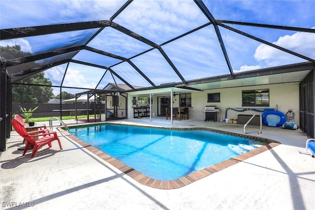 view of swimming pool with glass enclosure and a patio area