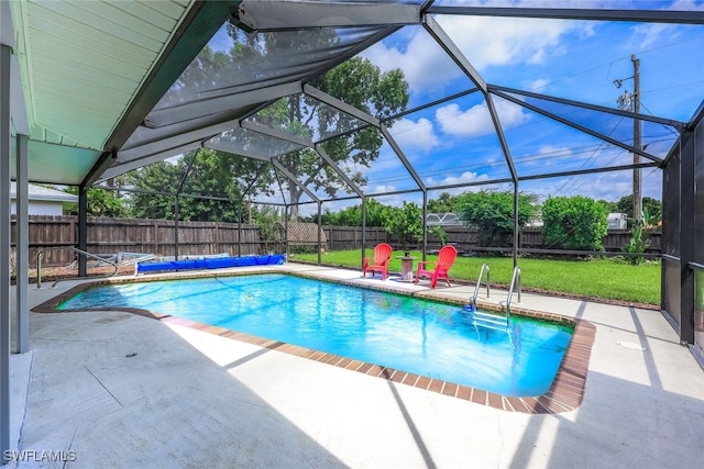 view of pool with a yard, a lanai, and a patio area