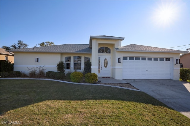 view of front of home with a front yard and a garage