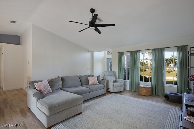 living room featuring lofted ceiling, light wood-type flooring, and ceiling fan