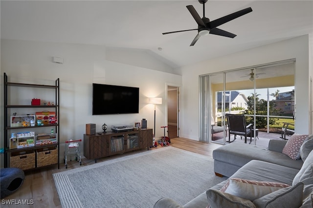 living room with ceiling fan, wood-type flooring, and vaulted ceiling