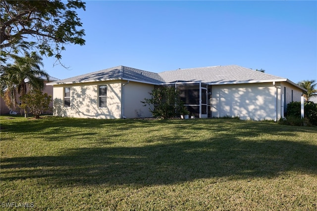 rear view of house with a lawn