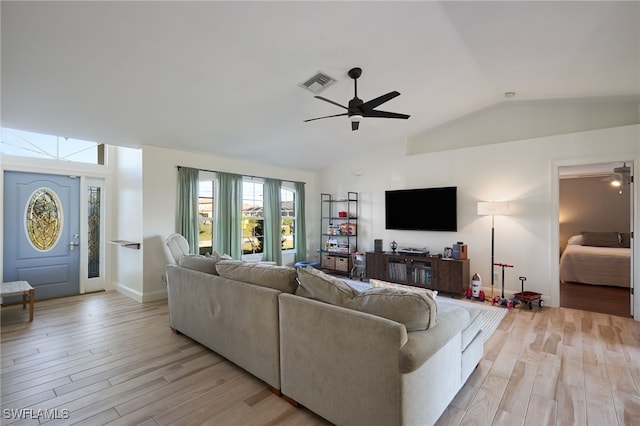 living room with light wood-type flooring, ceiling fan, and lofted ceiling