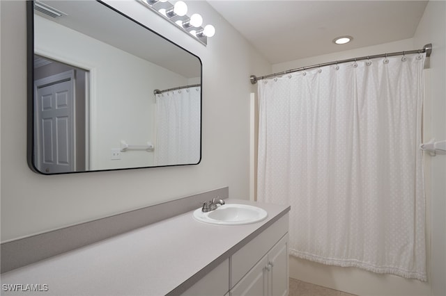 bathroom featuring vanity and shower / bath combination with curtain