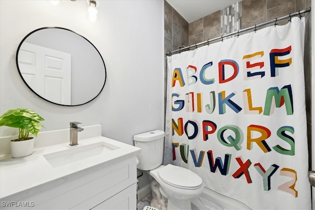 bathroom featuring vanity, toilet, and curtained shower