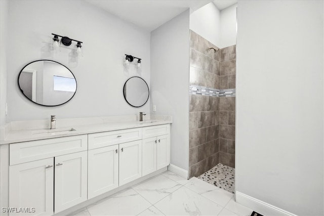 bathroom with vanity and tiled shower