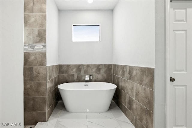 bathroom with tile walls and a washtub