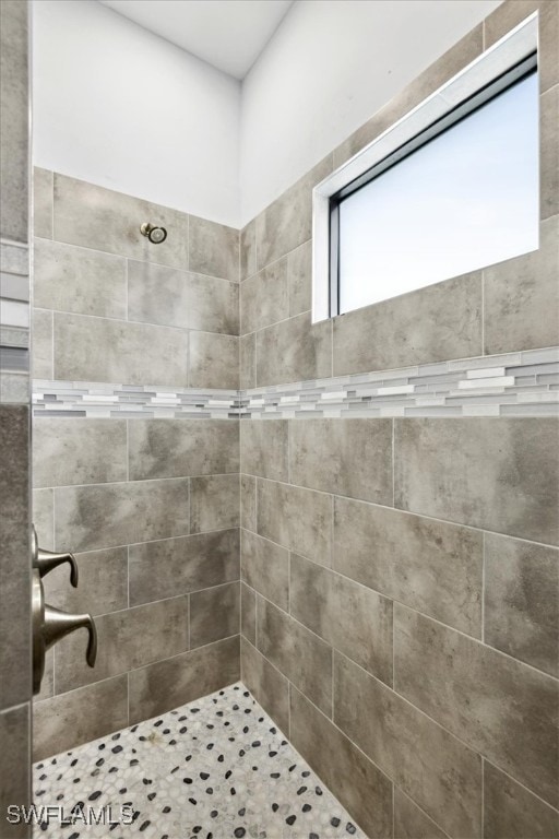 bathroom with tiled shower