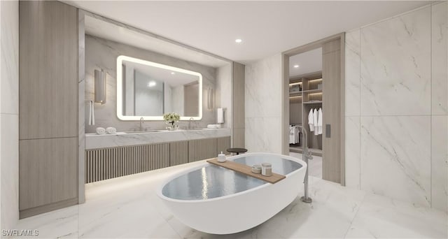 bathroom with a spacious closet, a freestanding bath, double vanity, marble finish floor, and a sink