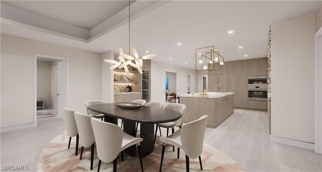 dining room with a notable chandelier, recessed lighting, and light wood-type flooring