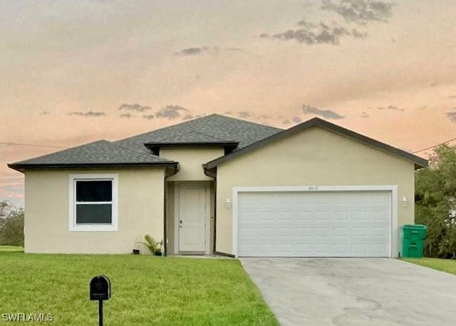 view of front of home with a lawn and a garage