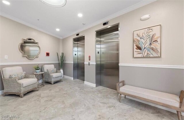 living area featuring ornamental molding and elevator