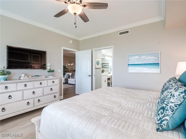 bedroom featuring ceiling fan, ornamental molding, ensuite bath, and light wood-type flooring