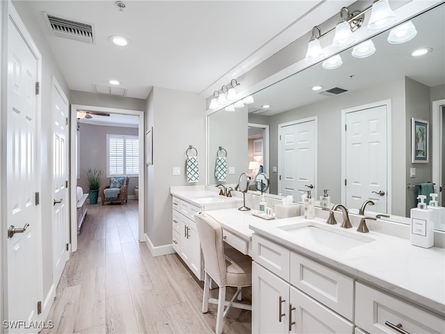 bathroom featuring vanity, hardwood / wood-style floors, and ceiling fan