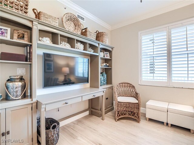 living area with crown molding and light hardwood / wood-style flooring