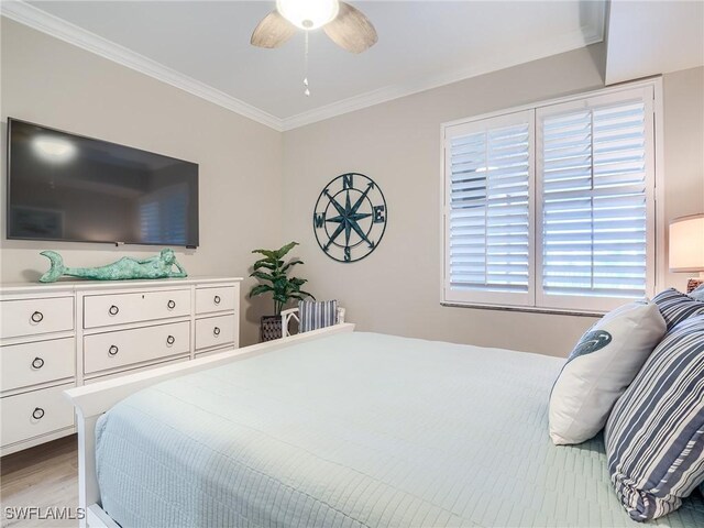 bedroom featuring crown molding, ceiling fan, and hardwood / wood-style flooring