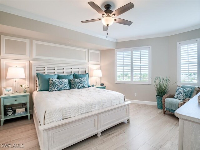 bedroom with crown molding, ceiling fan, multiple windows, and light hardwood / wood-style floors