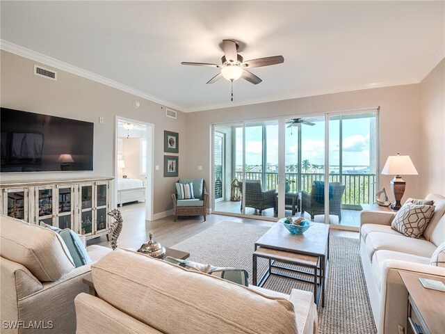 living room featuring ornamental molding, ceiling fan, and light hardwood / wood-style floors