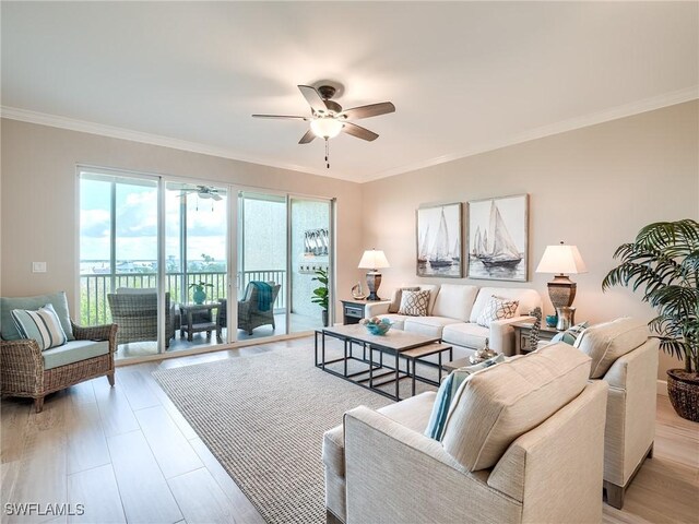 living room with ceiling fan, light hardwood / wood-style floors, and ornamental molding