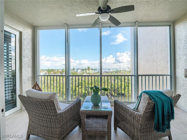 sunroom featuring ceiling fan