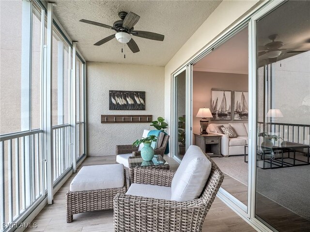 sunroom with a wealth of natural light and ceiling fan