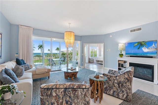 living room with a notable chandelier and light tile patterned floors