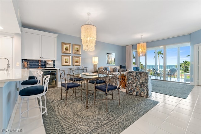 tiled dining room featuring a chandelier, sink, and wine cooler