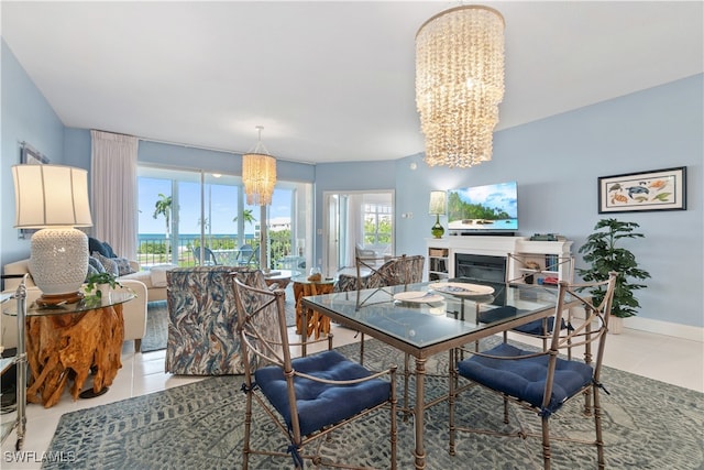 dining area featuring an inviting chandelier and light tile patterned flooring